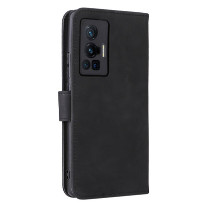 Black leather phone case with stitched flap and openings for camera and ports.
