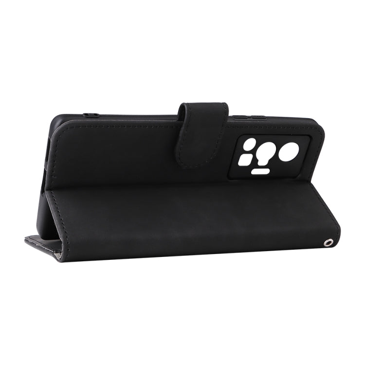Black leather folio phone case with magnetic flap and paw-print card holder.