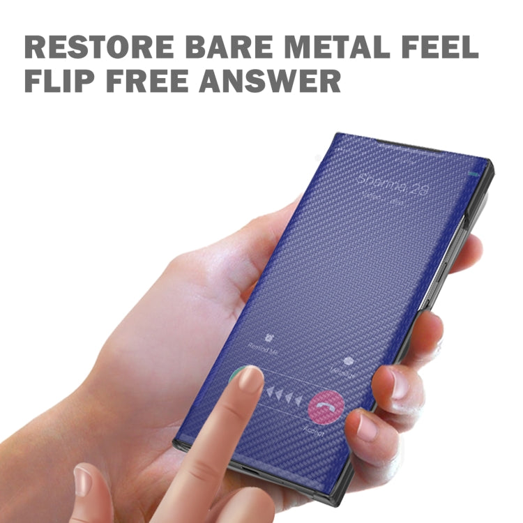 Carbon-fiber textured flip phone case, dark blue/purple, held closed in a hand.
