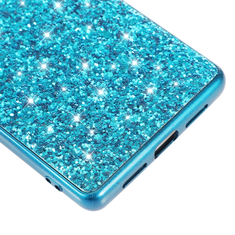 Blue glitter TPU phone case close-up showing bottom speaker and port cutouts.