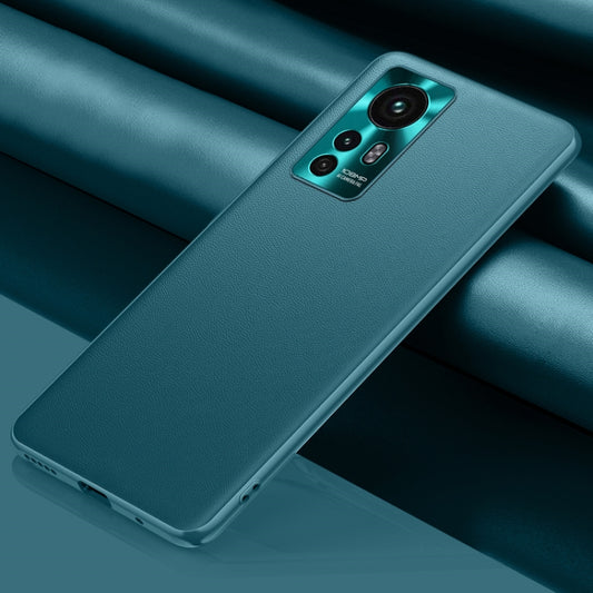 Teal leather phone case with camera cutout and raised edges for grip protection