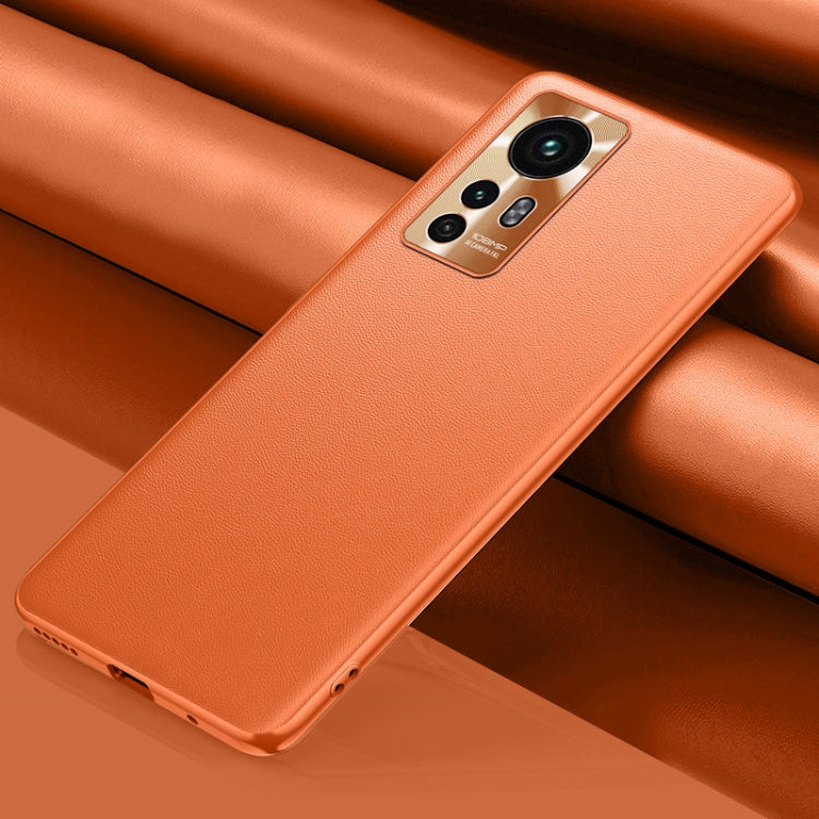 Orange leather phone case with camera cutout and raised edges for everyday protection