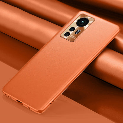 Orange leather phone case with camera cutout and raised edges for everyday protection