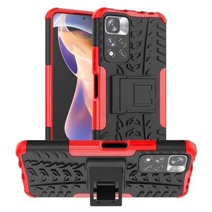 Red and black tire-texture TPU/PC phone case with built-in holder stand.