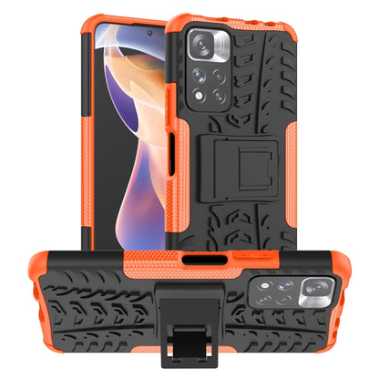 Orange and black tire-texture TPU/PC phone case with front camera and holder.