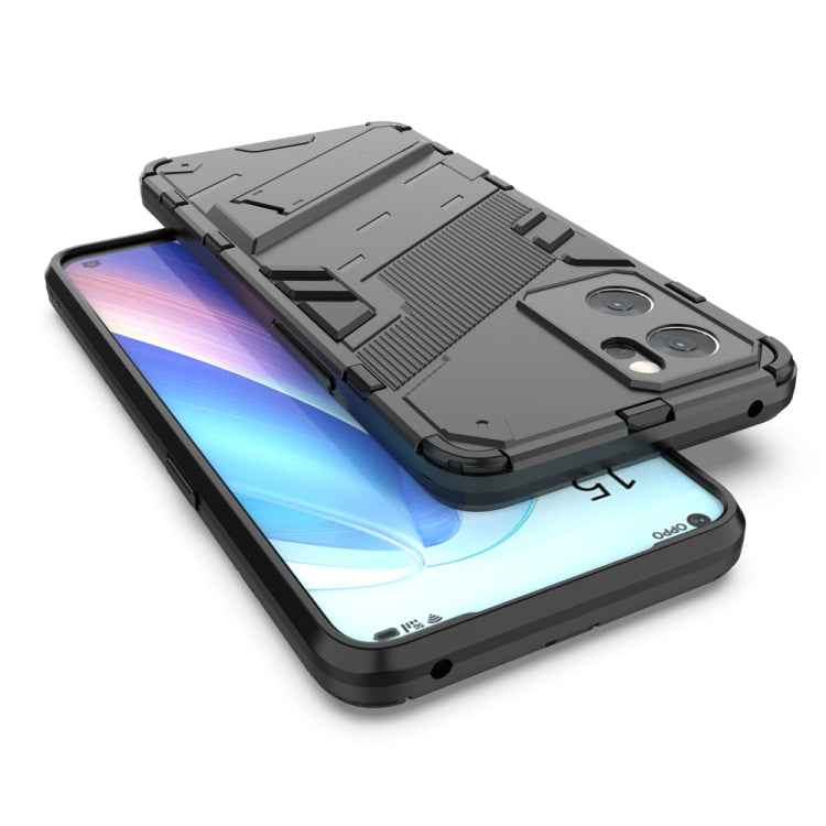 Black rugged phone case with kickstand, raised edges, and camera cutouts on phone