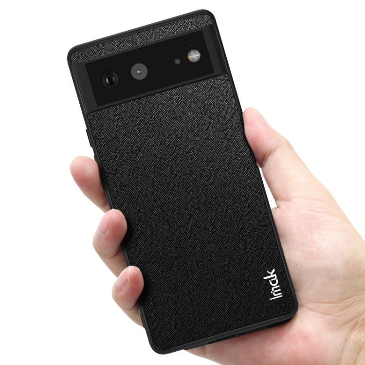 imak LX-5 phone case with screen protector, cross-texture dark finish, held in hand