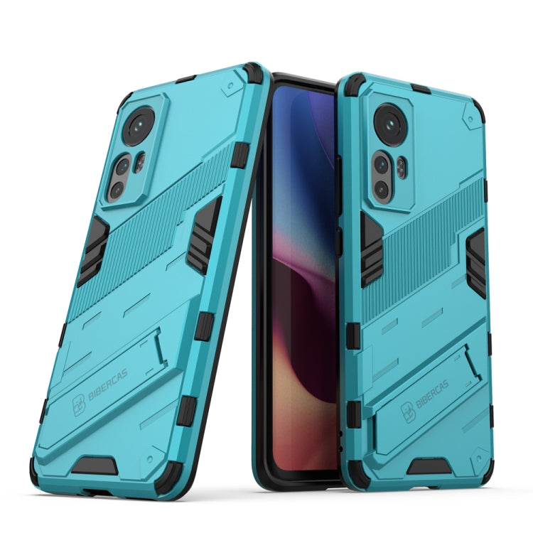 Rugged shockproof phone case with teal armor pattern and camera cutouts