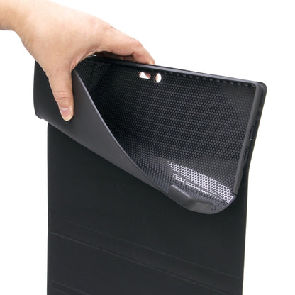 Hand holding dark textured folio keyboard case with outer mesh-like back panel