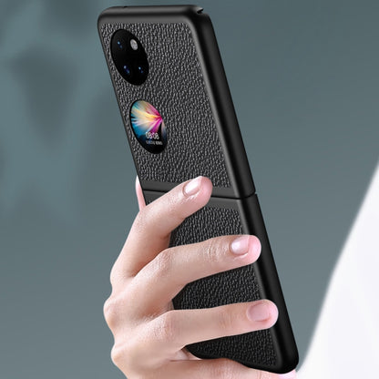 Blue litchi-texture shockproof case held in hand, showing camera and grip edges.