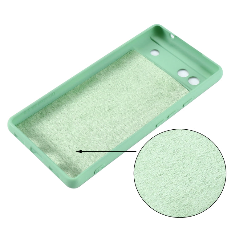 Mint green silicone phone case for Pixel 6a, inside texture with cutout holes