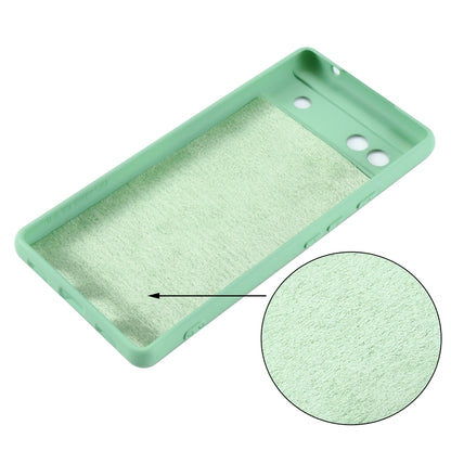 Mint green silicone phone case for Pixel 6a, inside texture with cutout holes