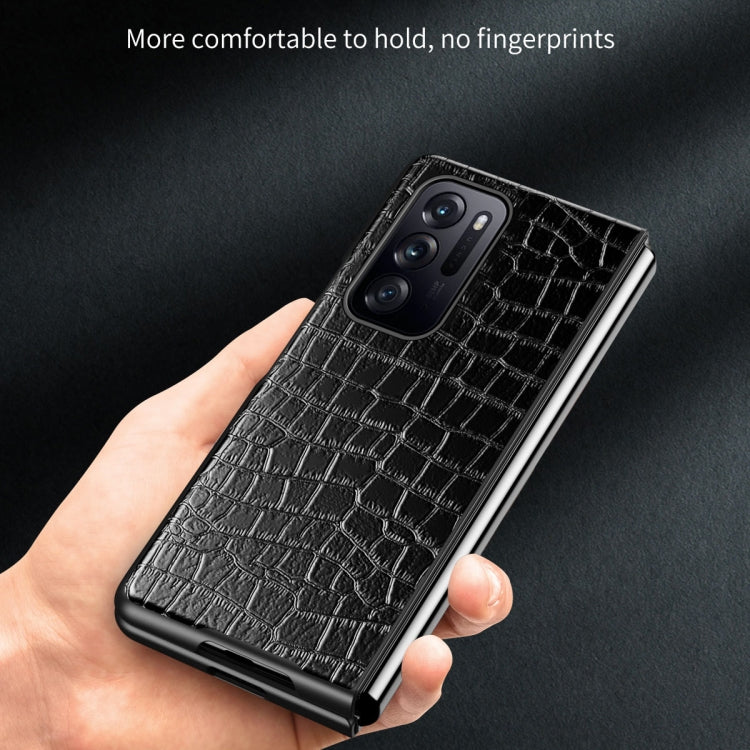 Black crocodile-texture leather phone case with triple camera cutout in hand