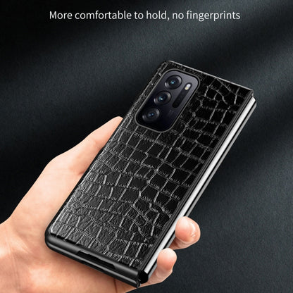 Black crocodile-texture leather phone case with triple camera cutout in hand