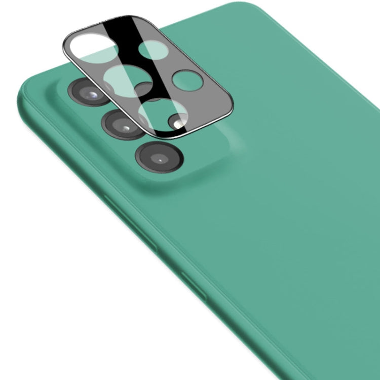 Black integrated rear camera lens tempered glass film with lens cap on green phone back