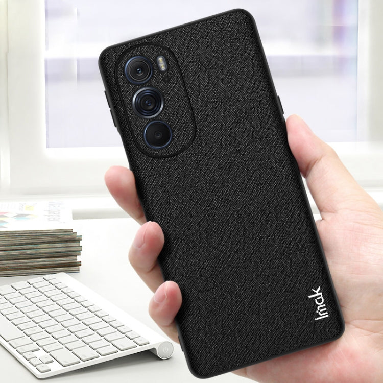 Black textured TPU phone case in hand with camera cutouts and secure grip