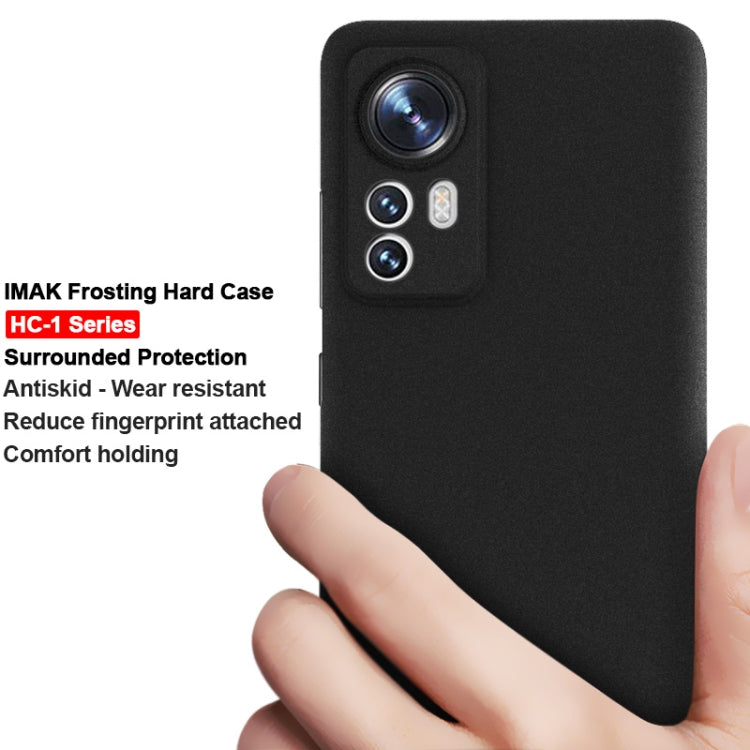 Black frosted hard phone case in hand, showing camera area and smooth matte finish