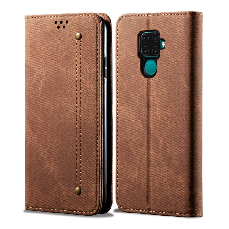 Brown denim-textured leather flip phone case with headphone/audio opening and multi-camera cutout