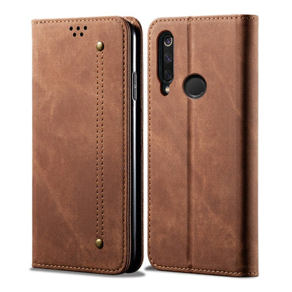 Brown denim-textured leather flip phone case with fingerprint sensor opening and camera cutout