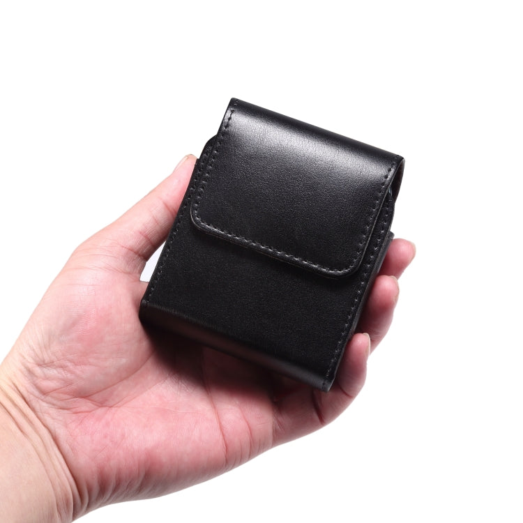 Black genuine leather waist phone case with snap flap, shown in hand