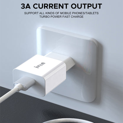 White travel USB charger plugged into a wall outlet with USB cable connected