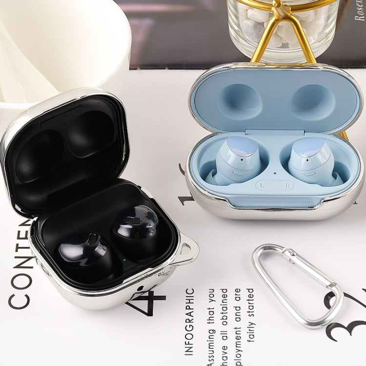 Earphone protective cases in blue and black, open lids with earbuds and carabiner