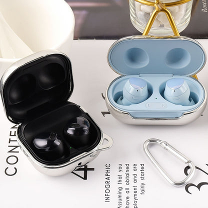 Earphone protective cases in blue and black, open lids with earbuds and carabiner