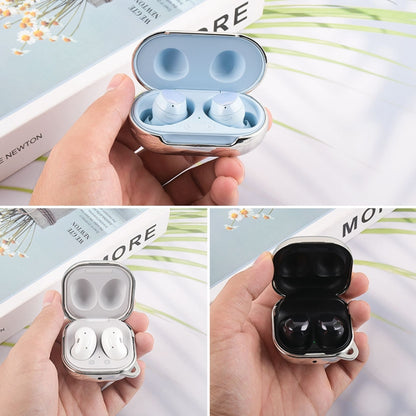 Hand-held earphone protective cases in blue, silver, and black with earbuds inside