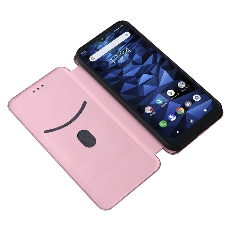 Pink flip phone case with smiley face cutout design; phone screen visible