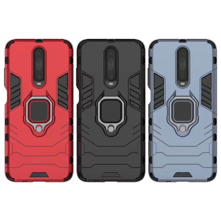 Rugged phone cases in red, black, and navy blue with magnetic ring holder detail