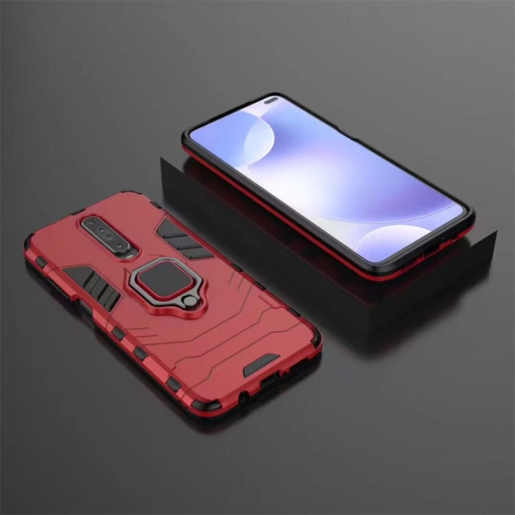 Rugged red phone case with magnetic ring holder and shockproof shell, beside a phone
