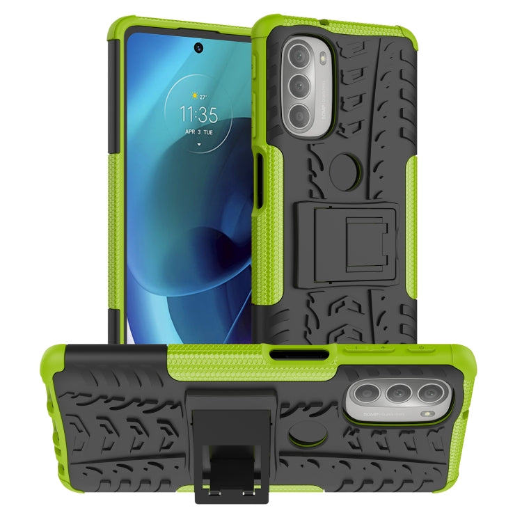 Rugged green phone case with tire tread texture and built-in kickstand holder