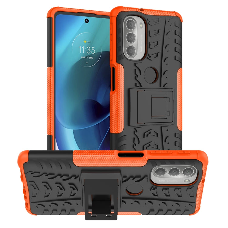 Orange tire-texture TPU phone case with built-in holder and camera cutout