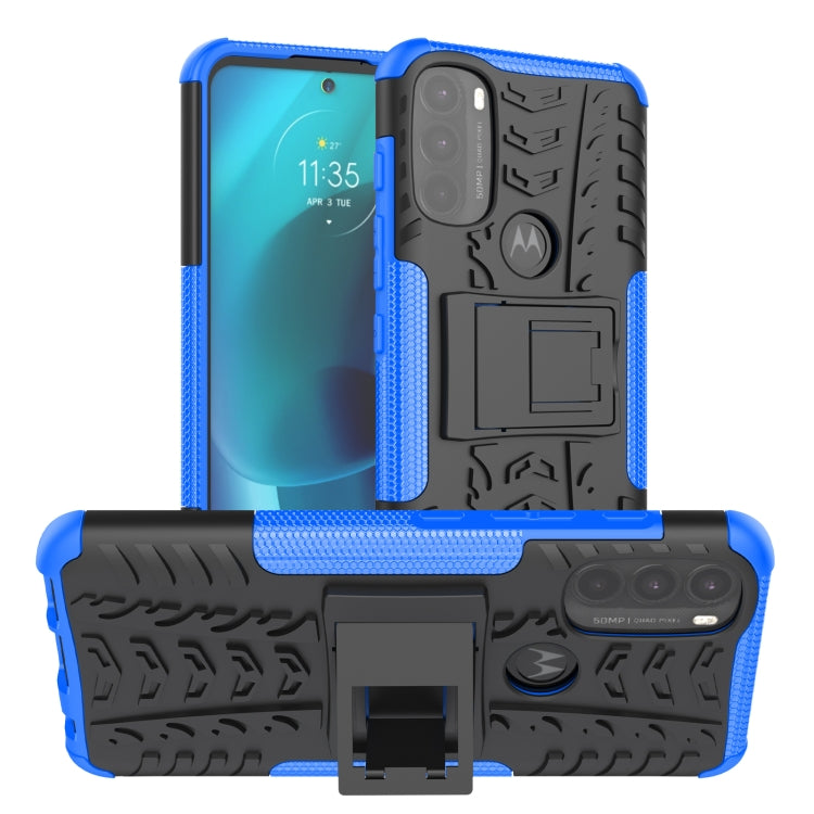 Rugged blue phone case with tire tread texture and built-in kickstand holder