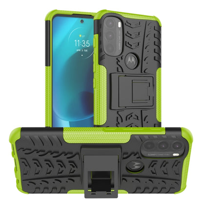 Rugged green phone case with tire tread texture and built-in kickstand holder