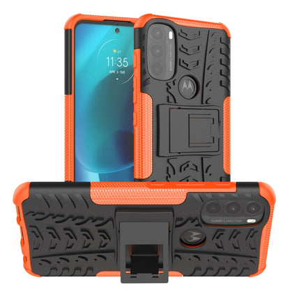 Orange and black tire-texture TPU phone case with kickstand holder and triple camera cutouts