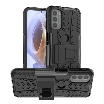 Rugged black phone case with tire tread texture and built-in kickstand holder