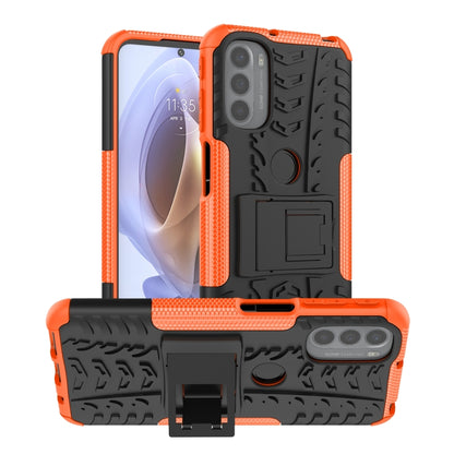 Orange tire-texture TPU phone case with holder and textured grip, phone back visible