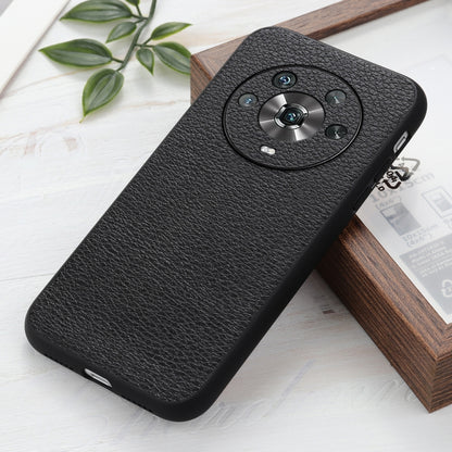 Black genuine leather phone case with litchi texture and circular camera cutout (angled).