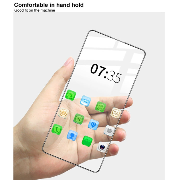 Tempered glass screen protector held on phone screen, clear, rounded edges.