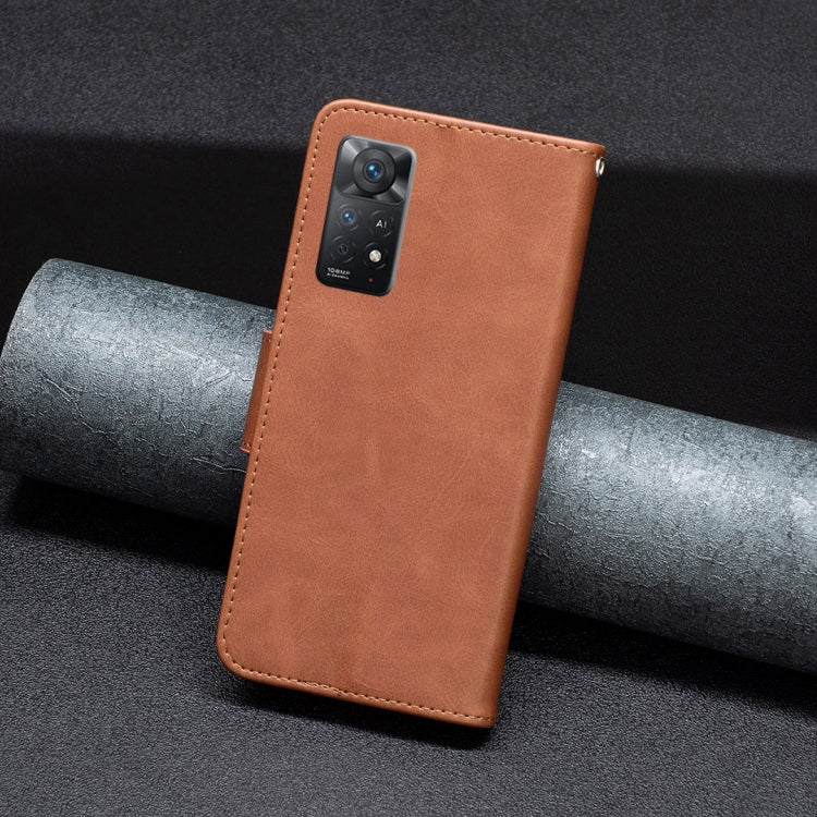 Brown leather flip phone case with camera cutout and wrist strap ring