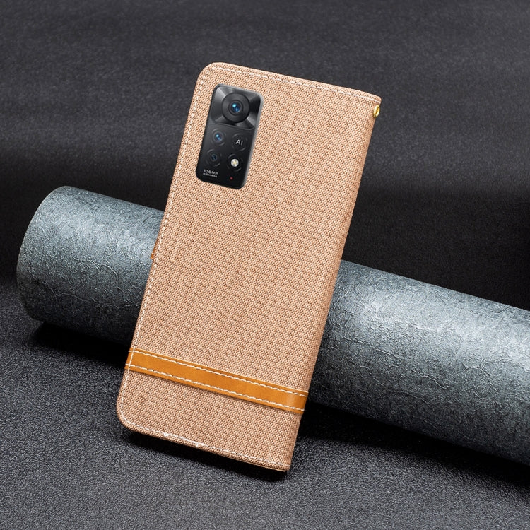 Brown denim-texture leather flip phone case with camera cutout and wrist strap