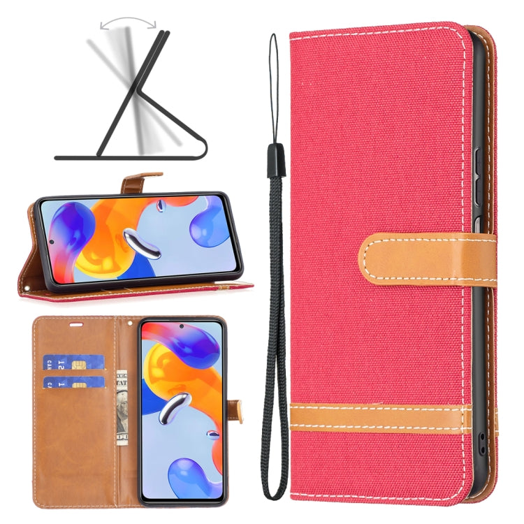 Red denim-texture phone wallet case with tan leather strap, stitching, and wrist lanyard.