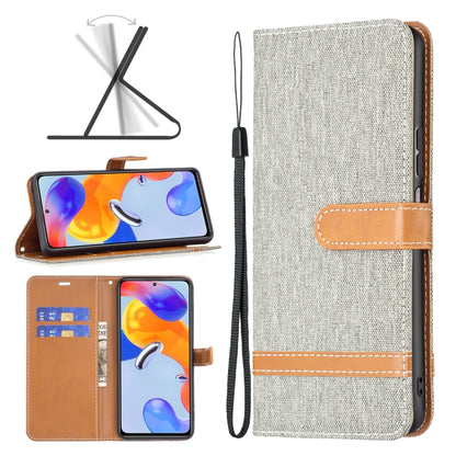 Light gray denim-texture phone wallet case with tan strap, stitching, and wrist lanyard.