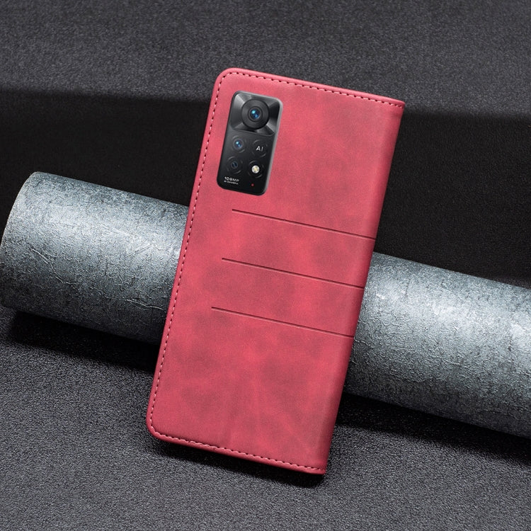 Red leather folio phone case with camera cutout and magnetic clasp, back view.