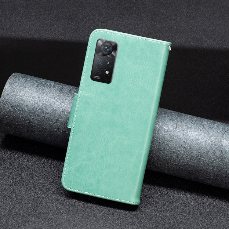 Mint green embossed butterfly leather phone case, back view with camera cutout