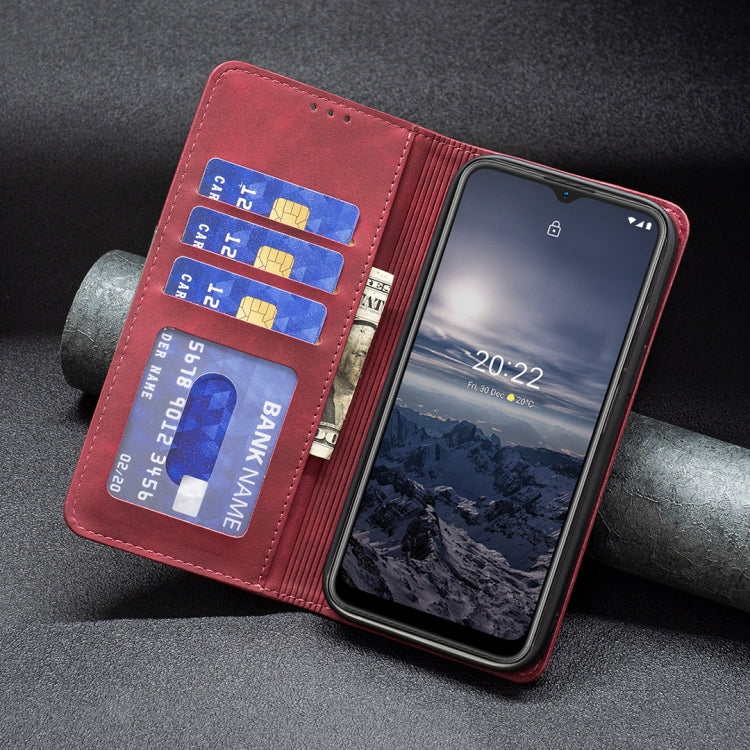 Red leather magnetic flip phone case with card holder and visible phone screen in it.
