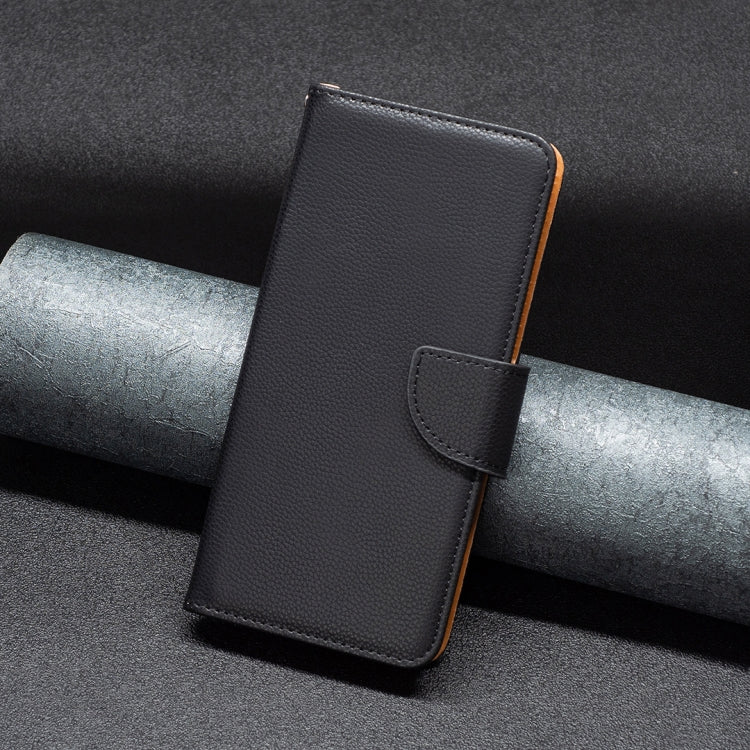 Black textured leather wallet phone case with foldover flap and wrist strap.