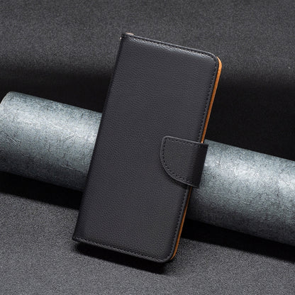 Black textured leather wallet phone case with foldover flap and wrist strap.