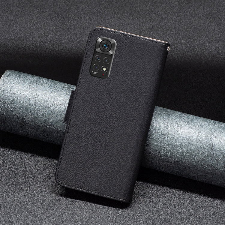 Black textured leather folio phone case with cover strap and camera opening.